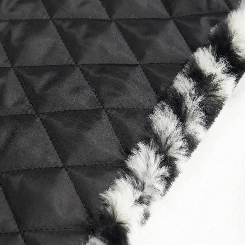 Interior detail of zebra stripe gothic jacket showing quilted black satin lining, fuzzy fur trim, and padded inner construction