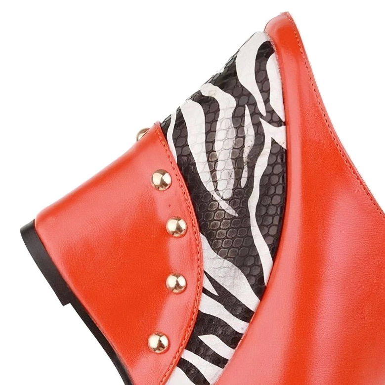 Side profile close-up of red zebra print wedge sandal displaying gold stud decoration and platform design